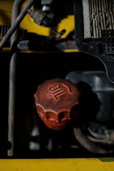 Detailed view of a red oil cap on machinery, emphasizing industrial design.